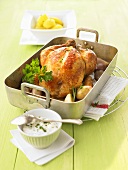 Roast chicken with shallots in a roasting tin