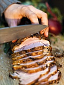 A joint of meat being sliced