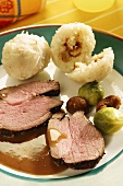 Roast leg of moufflon lamb with Brussels sprouts, chestnuts and dumplings