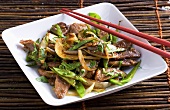 Work-fried duck fillet with mange tout and onions