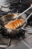 Pork roulade being fried in a pan