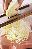 White cabbage being cut into strips