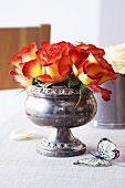 Roses in an old English silver bowl