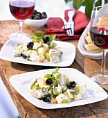 Potato and vegetable salad with black olives