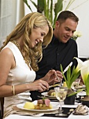 Couple eating veal fillet at elegant table