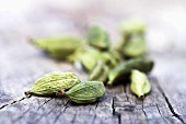 Cardamom pods on wooden background