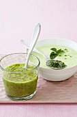 Cold herb soup in glass and pea soup with mint pesto