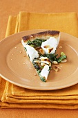 A slice of spinach and goat's cheese pizza