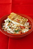 Fried zander on rice with peanuts and chilli