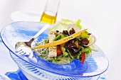 Salad leaves with marinated feta and olives