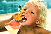 Child eating ice cream sundae