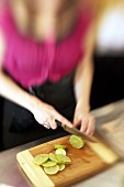 Woman slicing limes in a bar