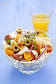 Pasta salad with chicken breast, tomatoes, onion and olives