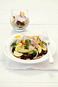 Bean salad with courgettes, tomatoes, avocado, onion and egg