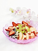 Fruit salad with avocado cream and flaked almonds