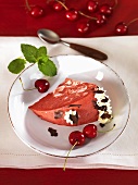 A piece of red and white ice cream bombe