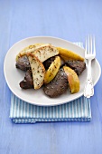Fried turkey liver with apple wedges