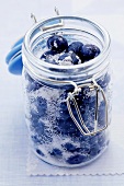 Sugared blueberries in preserving jar (Vaccinium corymbosum)