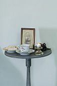 Tea, biscuits, photo and nightlight on round table