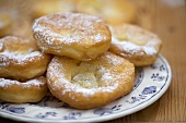 Deep-fried pastries with icing sugar on a plate