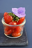 Halved cherry tomatoes and cress in a jar