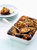 Plum crumble in baking dish and on plate