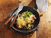 Steak with blue cheese, bacon and mushrooms in frying pan