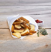 Potato wedges in paper bag, ketchup