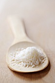 Grated coconut on wooden spoon