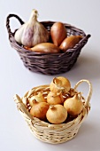 Onions, shallots and garlic in baskets