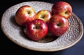 Several red apples on plate