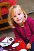 Little girl at dining table