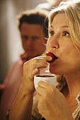Woman eating a chocolate-dipped strawberry