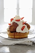 St. Honoré cake with profiteroles, cream and strawberries