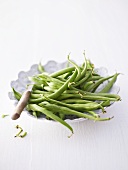 French beans on plate with knife