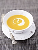 Pumpkin soup with crème fraîche in soup cup