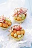 Charentais melon balls with ham in hollowed-out melons