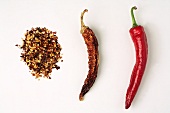 Chilli flakes, one dried and one fresh chilli