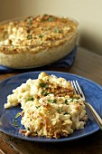 Macaroni cheese in baking dish and on plate