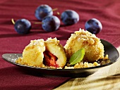 Plum dumplings with buttered breadcrumbs and icing sugar