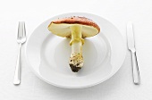 A fly agaric toadstool on white plate
