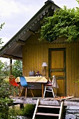 Wooden summer house with table and chairs on verandah