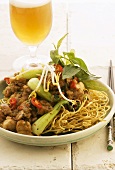 Deep-fried noodles with chicken and vegetables, beer (Asia)