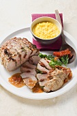 Stuffed roast veal with ham, tomatoes and saffron risotto