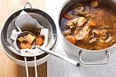 Making veal stock: straining the stock