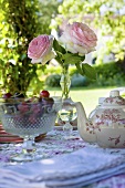 Teapot, cherries & roses on garden table (Château de la Verrerie, France)