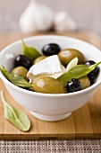 Marinated olives with Camembert and basil