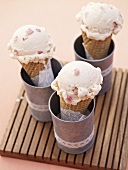 Three ice cream cones each with a scoop of ice cream