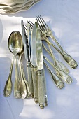 Antique silver cutlery on table