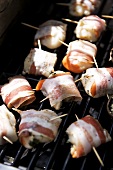 Bacon-wrapped scallops on a barbecue